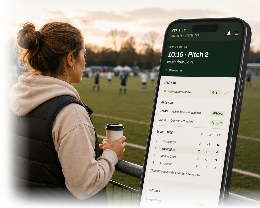 Parent at a grassroots football tournament checking the Zokko Tournament View on a phone